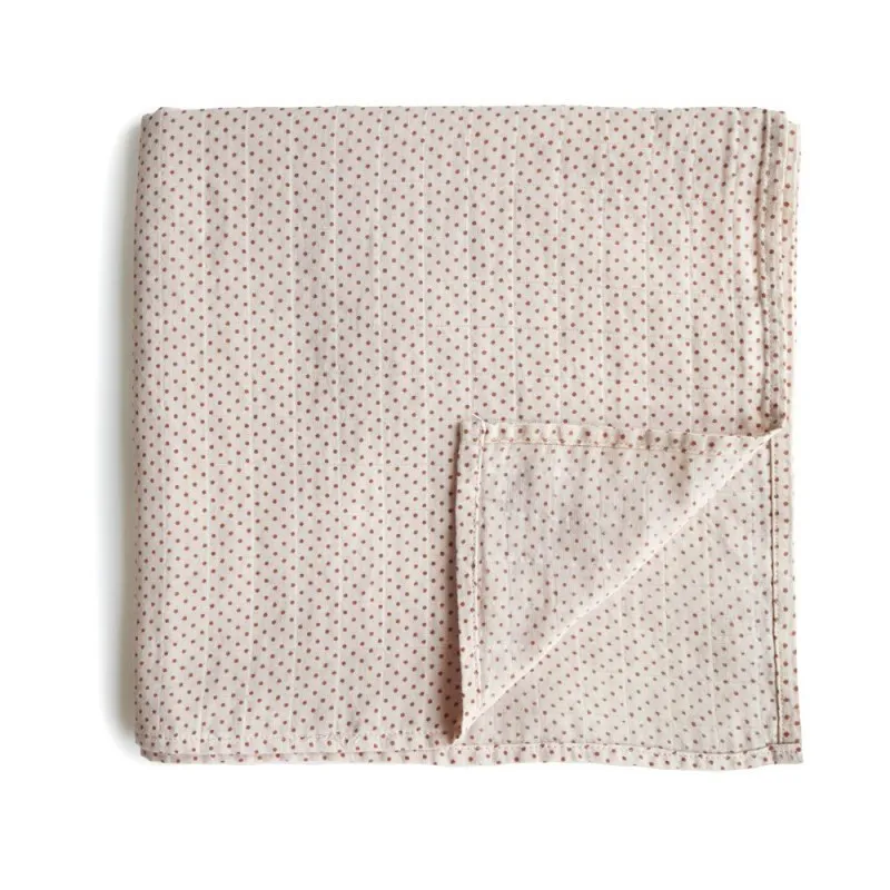 caramel polka dots mushie swaddle